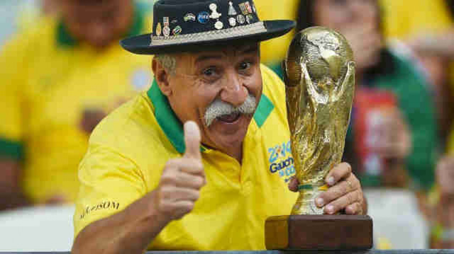 Bức ảnh chứa đựng câu chuyện xúc động về người đàn ông cầm cúp đi cổ vũ World Cup suốt gần nửa cuộc đời - Ảnh 1.